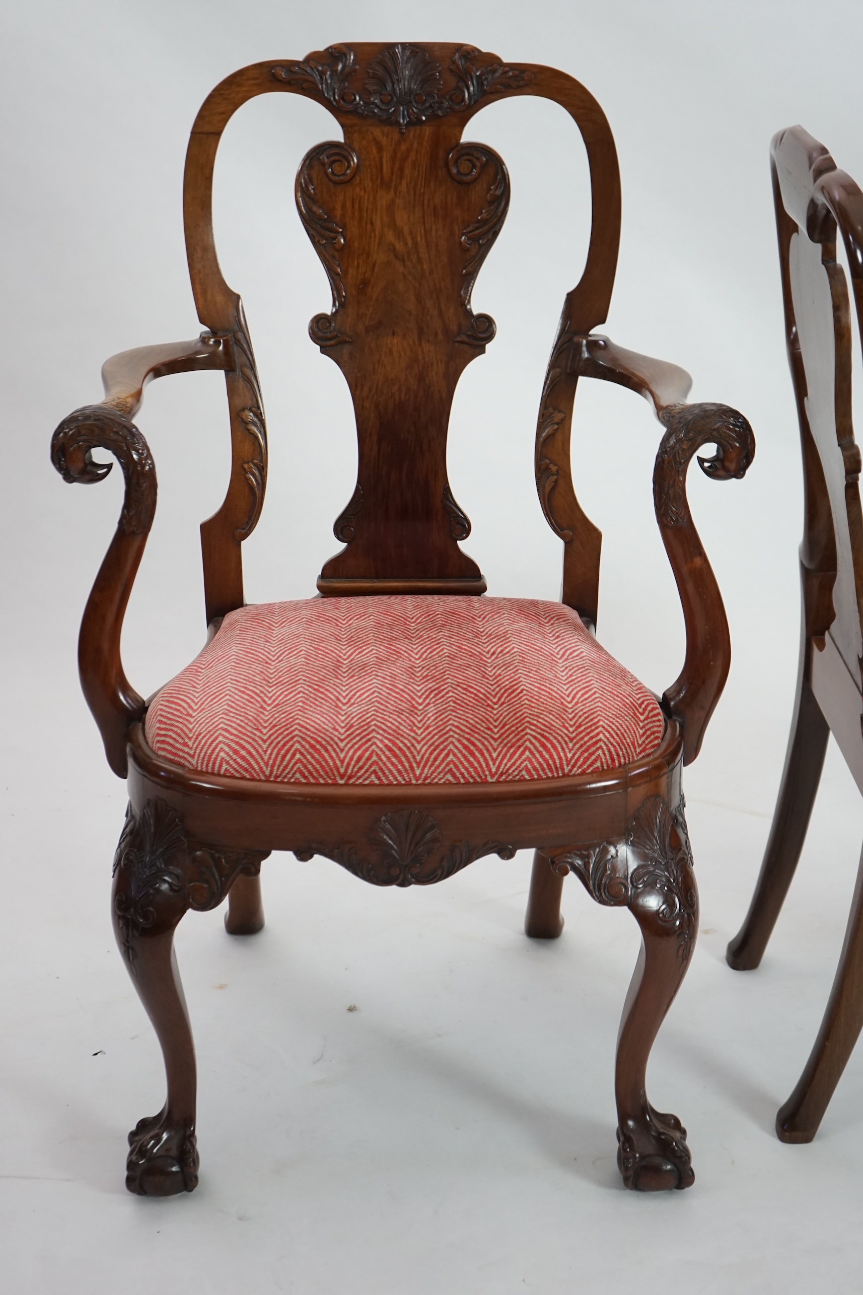 A set of twelve Queen Anne revival walnut dining chairs, including two carvers